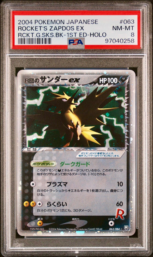 PSA 8 - Rocket’s Zapdos ex 063/084 Rocket Gang Strikes Back 1st Ed - Pokemon